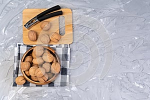 Hand cracking walnuts. walnuts and shells on a wooden table. selective focus