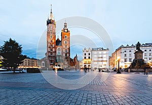 Cracow, Poland old town with St. Mary's Basilica and Adam Mickiewicz monument at the evening