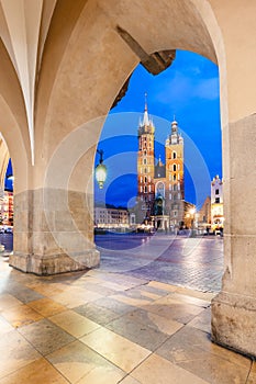 Cracow, Poland old town and St. Mary's Basilica seen from Cloth hall arch at night