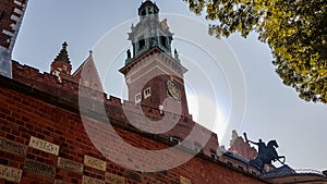 Cracow - A view on the tall bell tower of Wawel Castle in Cracow, Poland. There is a high defence wall around the castle
