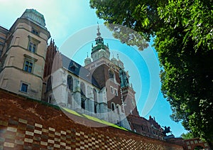 Cracow - A view on the tall bell tower of Wawel Castle in Cracow, Poland. There is a high defence wall around the castle