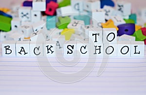 Craft beads and alphabet blocks spell Back to School