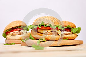 Craft beef burger on wooden table on light background
