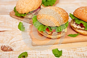 Craft beef burger on wooden table on light background
