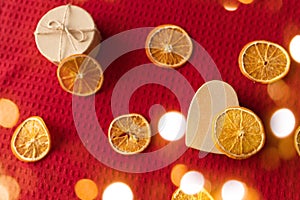 Craft box and dried oranges on a red background with copy space. Healthy sweets concept. Flat lay
