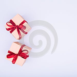 Craft boxes with dark red ribbon bows. Holiday, Christmas, New Year and Valentine day eco-friendly wrapping concept