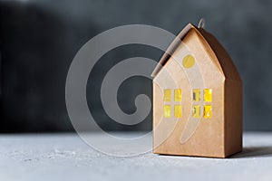 Craft cardboard box house with luminous window, creative gift packaging