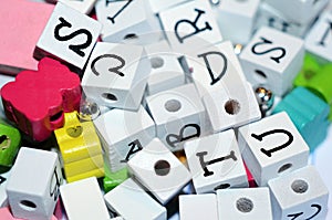 Craft colored beads and alphabet block letters jumble