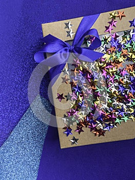 craft gift box with satin blue bow and colorful stars