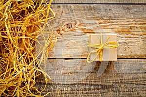 Craft gift box on wooden table with raffia or twine