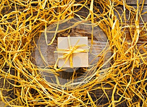 Craft gift box on wooden table with raffia or twine