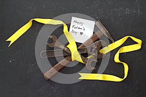 Craft gift with old tool on black background. Fathers day concept. Flat lay. hammer, pliers and spanner.