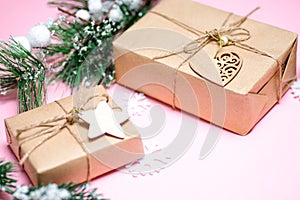Craft gift on pink background fir branches