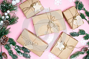 Craft gifts with fir twigs on a pink background