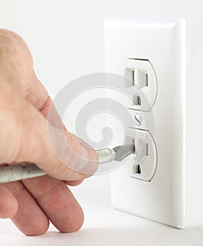 Craft knife in electrical outlet photo