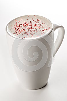 Craft latte coffee with berries powder on top in white ceramic mug. White background. Best for commercial. Content for coffee addi