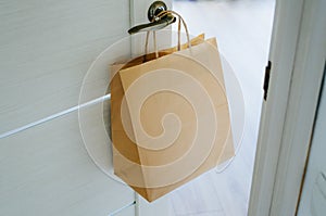 The craft package hangs on the handle from the front door.