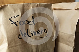Craft packages with food delivery on dark wooden background
