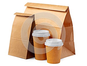 Craft paper bag and coffee to go cups on white background