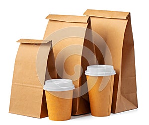 Craft paper bag and coffee to go cups on white background