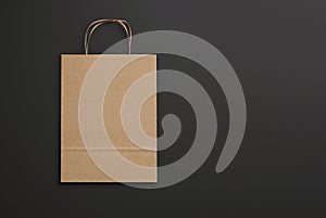 Craft paper bag with handles on black background. 3d render