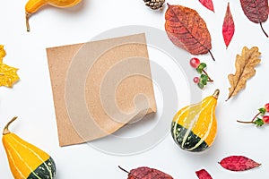 Craft paper blank frame and autumn leaves, pumpkin, background. Autumn mockup. Autumn composition, fall concept. Flat