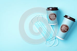 Craft paper cups with coffee to go and food box, lunch on blue background. Top view. Banner, copy space. Safe delivery, take away