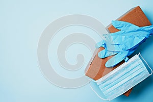 Craft paper cups, food box, gloves, bags, mask on blue background. Top view. Banner, copy space. Safe delivery, take away only