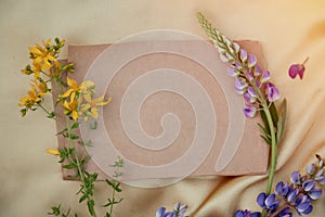 Craft paper mock up. Lupins purple flowers decorations. Natural, wellness closeness to nature. Summer invitation