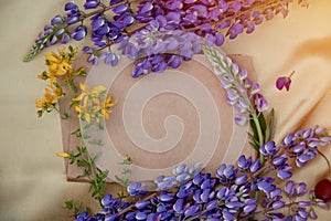 Craft paper mock up. Lupins purple flowers decorations. Natural, wellness closeness to nature. Summer invitation