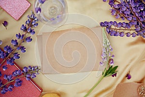 Craft paper natural mock up. Lupins purple flowers, wine glass decorations. Summer invitation, birthday card, Mother