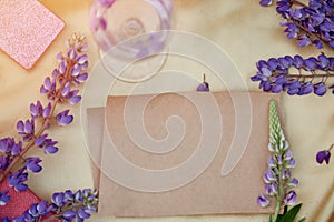Craft paper natural mock up. Lupins purple flowers, wine glass decorations. Summer invitation, birthday card, Mother