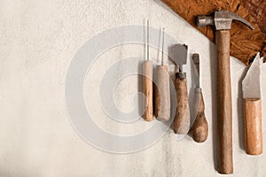 Craft tools for work with leather on light background