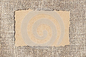 Craft torn paper, top view on burlap background. Copy Space