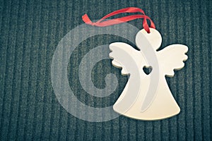 Craft Wooden Angel on Grey Knitted Background