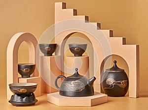 Crafted ceramic teacups and teapots, arranged in an aesthetically pleasing manner
