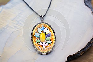 crafting a beaded pendant with a metal frame