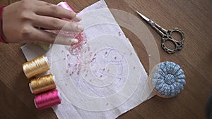 Crafting Harmony: Hand Sorting Beads for Embroidery on Wooden Table