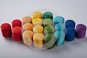 A vibrant array of thread spools organized in a perfect color gradient.