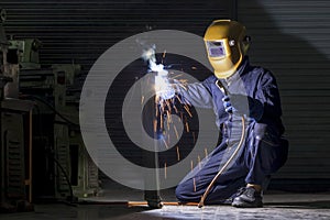 A craftman is welding with workpiece steel.