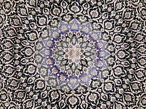 Crafts. Central part of an old carpet with an oriental pattern. Background.