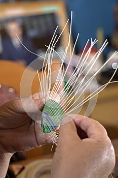 Craftswoman's hands weaving with horsehair photo