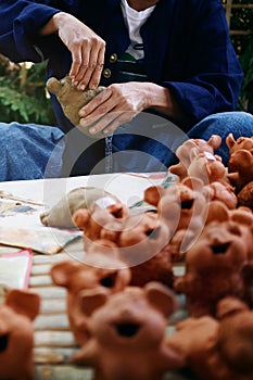 Craftsman artist hands making cute animal pottery or handcraft clay dolls demonstrating in local craftsmanship market