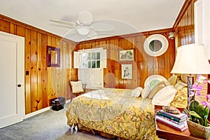 Craftsman bedroom interior with wooden pannel walls.