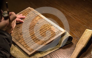 A craftsman carving a wooden printing block