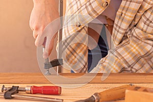 Craftsman with clamps working with wood. Crop unrecognizable male carpenter installing clamps and vices for gluing