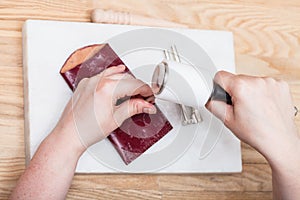 Craftsman corrects embossing of leather pouch