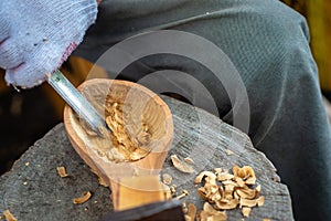 Craftsman demonstrates the process of making wooden spoons handmade using tools.