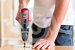 Craftsman or DIY man working with power drill