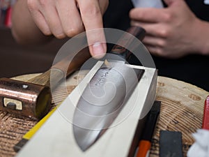 Craftsman with engraved handmade Japanese knife